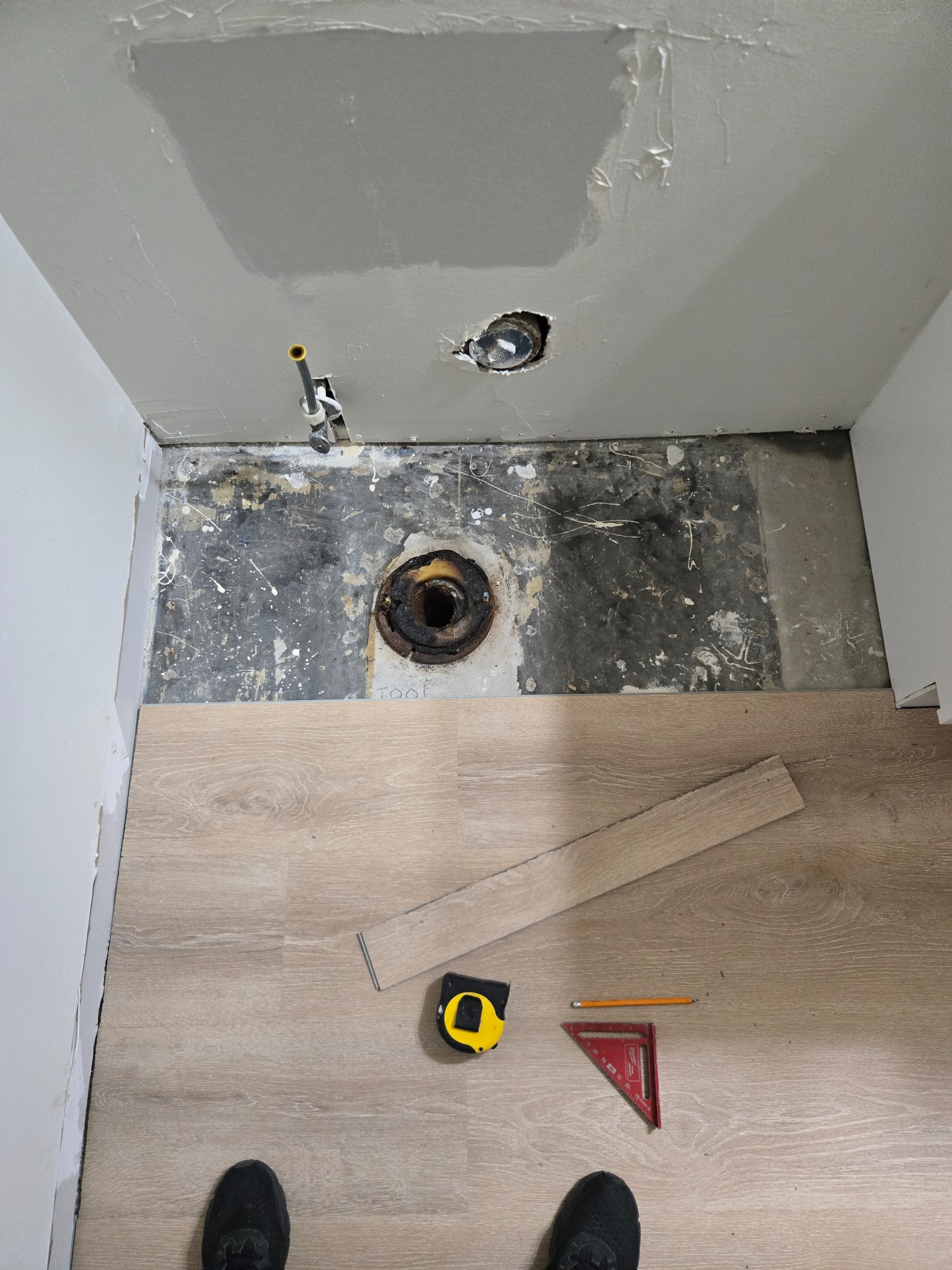 During — fitting flooring around existing plumbing